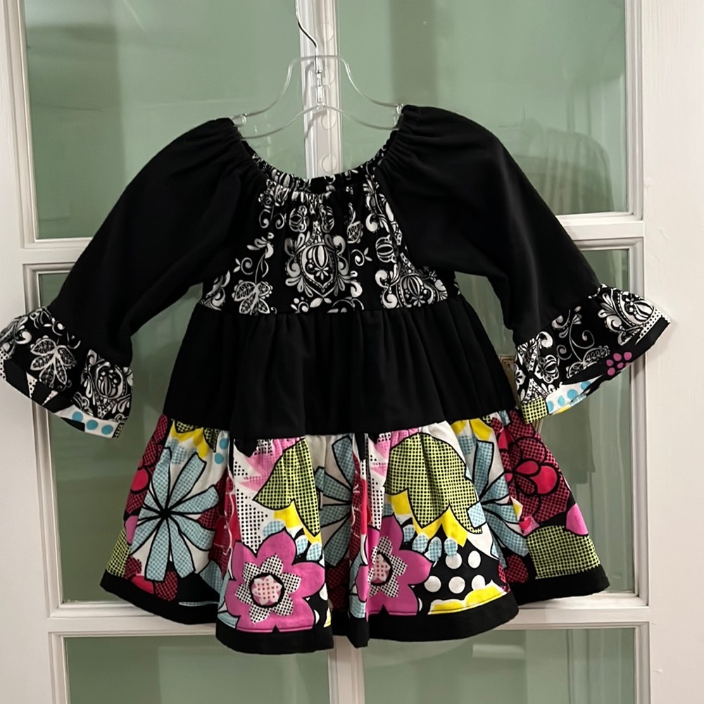 New handmade girls’ three tiered flannel dress in a size 18 months.